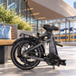 Nederlands
Opgevouwen grijze PACTO E‑ONE elektrische vouwfiets bij Rotterdam Centraal, klaar om mee te nemen in de trein.

English
Folded grey PACTO E‑ONE electric folding bike at Rotterdam Central Station, ready to take on the train.